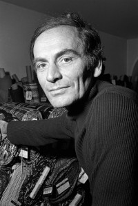 Pierre Cardin at his studio in Paris with bolts of fabric