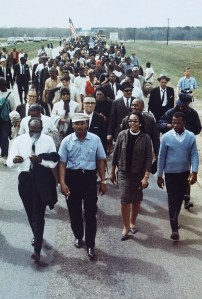 Martin Luther King Jr.,  with his wife Coretta (right) and John Lewis (far right), leads a march from Selma to Montgomery, Alabama, March 1965.