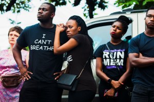 Keara Lipscomb, third from left, 24, leans on Ayo Akinmoladun, second from left, 25, during the Black Lives Matter Memphis Chapter protest against violence by police near South Parkway and Mississippi Friday evening, July 8, 2016 in Memphis, Tenn.