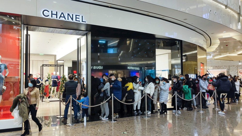 Shoppers line up outside a Chanel store in Shanghai, China on the last day of 2020.