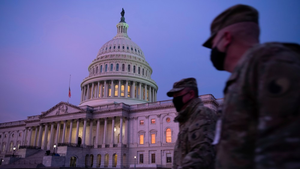 Members of the U.S. National Guard walk past the U.S. Capitol Building ahead of Inauguration in Washington, D.C., on January 15, 2021, amid the coronavirus pandemic. More than 20,000 members of the U.S. National Guard are stationed in Washington in the lead up to President-Elect Joe Biden's inauguration. (Graeme Sloan/Sipa USA)(Sipa via AP Images)