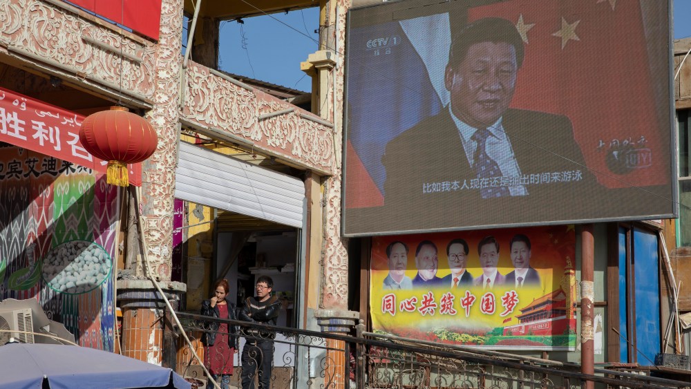 Chinese President Xi Jinping is seen on a screen in a Xinjiang bazaar.
