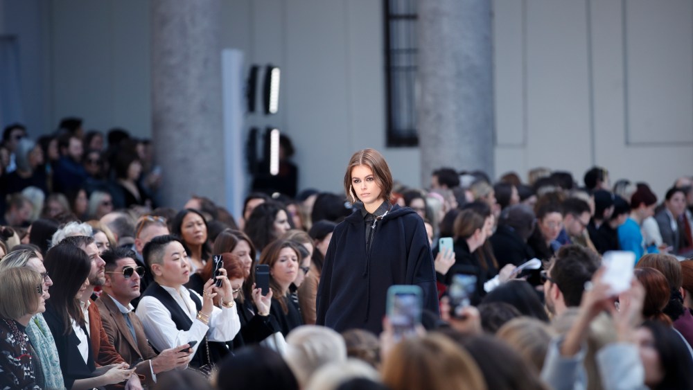 Model Kaia Gerber wears a creation as part of Max Mara's Fall/Winter 2020/2021 collection, presented in Milan, Italy, Thursday, Feb. 20, 2020. Sitting at left is Anna Wintour. (AP Photo/Antonio Calanni)
