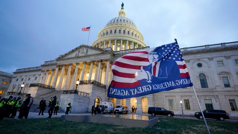 A flag left by pro-Trump rioters outside the Capitol building they bombarded.