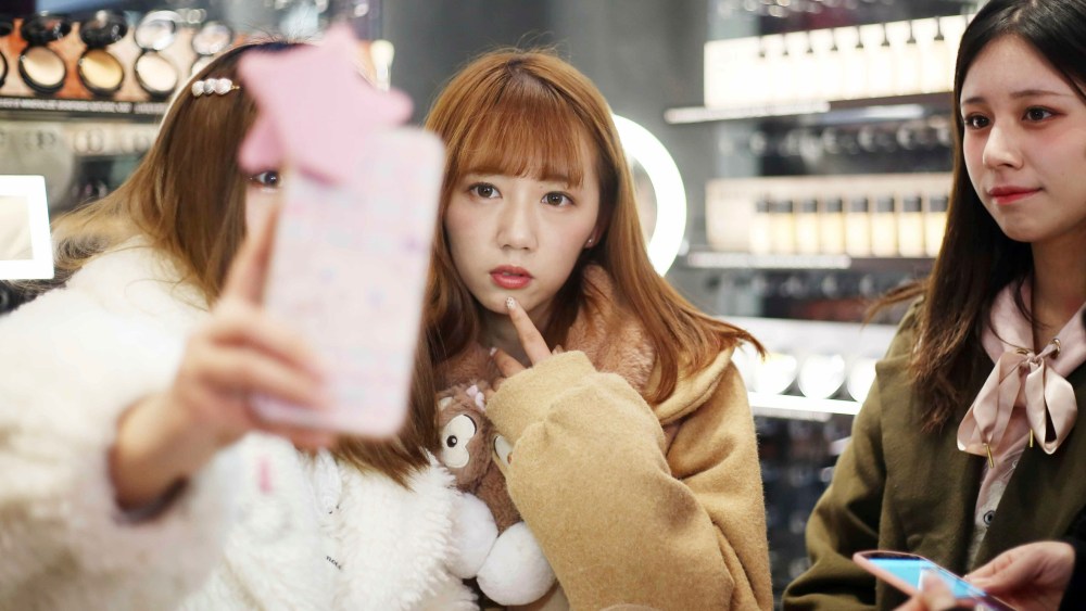Customers pose for selfies at the Huaihai Road flagship store of makeup brand MAC Cosmetics themed on Tencent's MOBA "King of Glory" in Shanghai, China, 17 January 2019. The Huaihai Road flagship store of makeup brand MAC has been changed into a store themed on Tencent's MOBA 'King of Glory'. Themed limited lipstick collections are launched at the store.  (Imaginechina via AP Images)
