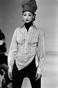 A model walks the runway in corset waist tie-dyed puffer coat with faux fur trim designed by Byron Lars for fall 1994.