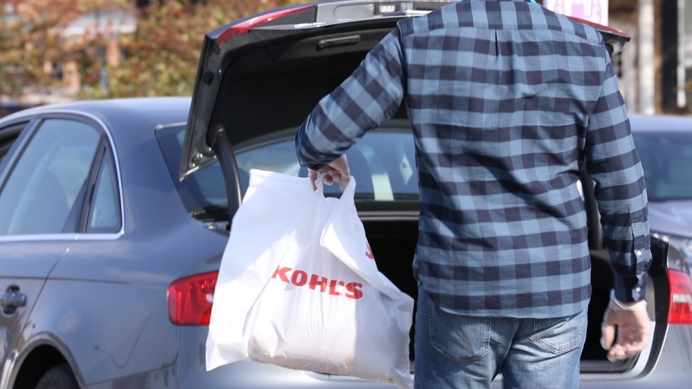 shopper taking kohl's shopping bag to car