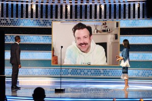 Jason Sudeikis in Listen + Lead Tie Dye Hoodie (c) accepts the Best Television Actor – Musical/Comedy Series award for ‘Ted Lasso’ via video from Sterling K. Brown (l) and Susan Kelechi Watson.