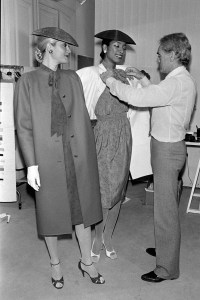 Designer Philippe Venet adjusts a look on a model during a fitting for his Spring 1980 Couture Collection Advance.