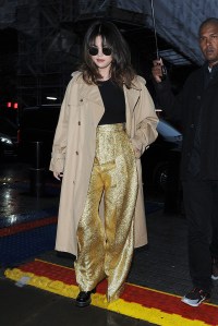 Selena Gomez leaves her hotel, and arrives at the Radio 1 studios, wearing sparkly gold trousers and a tan coloured coat. She completed the look with a pair of sunglasses. 11 Dec 2019 Pictured: Selena Gomez. Photo credit: Will / MEGA TheMegaAgency.com +1 888 505 6342 (Mega Agency TagID: MEGA566451_011.jpg) [Photo via Mega Agency]