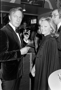 (L-R) Christopher Plummer, Elaine Plummer, and Michael Caine (partially obscured) attend a screening at the Loews Astor Plaza cinema and an afterparty at Nathan's Famous in New York City on December 16, 1975.