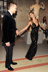 Tom Brady (L) in Tom Ford and Gisele Bündchen in Balenciaga attend the Metropolitan Museum of Art's 2014 Costume Institute Gala featuring the opening of the exhibit "Charles James: Beyond Fashion."