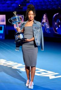 Japanese tennis player Naomi Osaka, winner of the 2019 Australian Open, poses for a photo with the tournament's trophy, at a talk show in Melbourne on Jan. 16, 2020, during a draw for the 2020 Australian Open, set to begin on Jan. 20. (Kyodo via AP Images) ==Kyodo