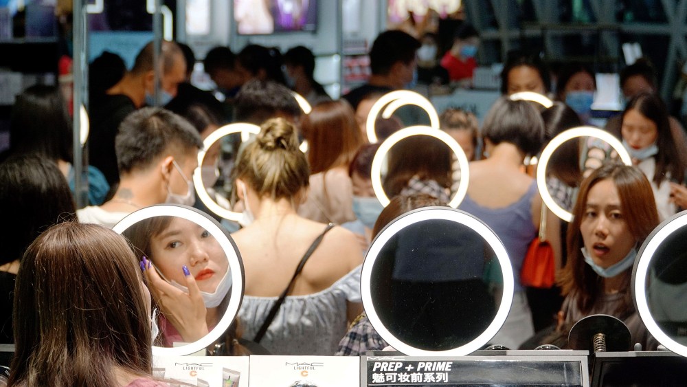 Chinese shoppers trying on beauty products in a duty free shop on Hainan Island, China.