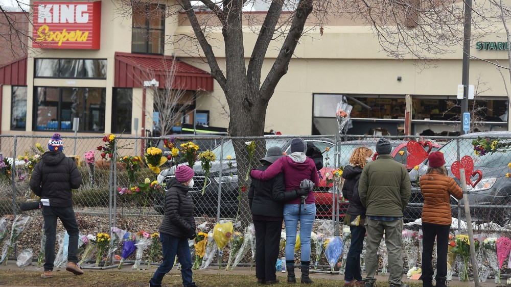 The flowers were growing by the hour on Tuesday, March 23, 2021. They were left by multitudes of mourners for the 10 people killed at the Boulder King Soopers in Boulder, Colo. on Monday. (Jerilee Bennett/The Gazette via AP)