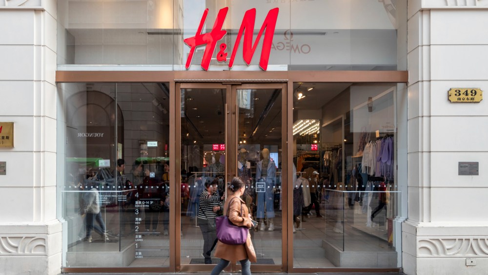 A woman walks by an H&M store in Shanghai, China Wednesday, March 24, 2021. The Swedish fast-fashion brand has attracted boycott from its Chinese customers after indicating forced labor existing in Xinjiang.
