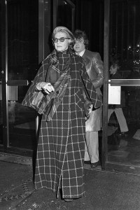 Designer Pauline Trigere in a floor-length windowpane plaid coat at a screening of "The Day of the Dolphin" at the Ziegfeld Theater in New York, 1973.