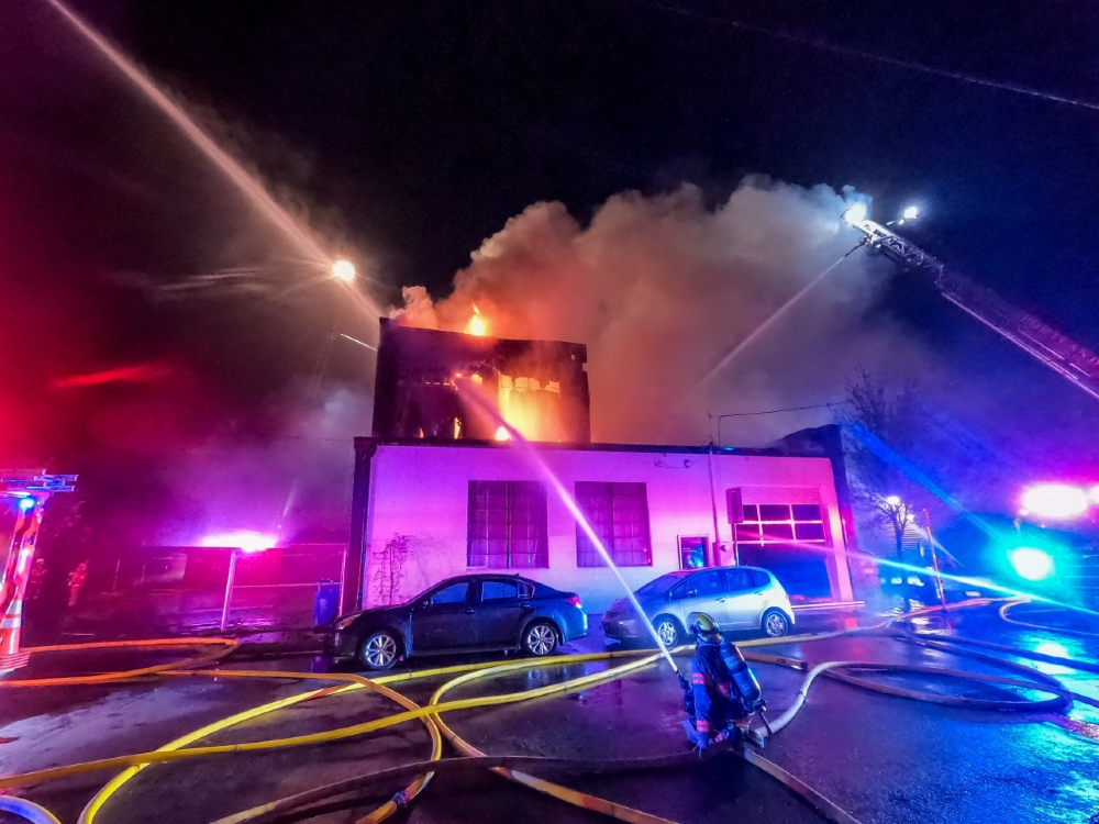 Officials are looking for the arsonist who torched Oregon's Portland Garment Factory, which has served Adidas, Nike, Levi's and New Balance.