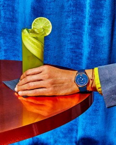 Chanel MonsieurÕs Blue Edition watch featuring a white gold and grained navy blue dial with jumping hour and 240-degree retrograde minute. Cartier Juste un Clou 18-karat yellow gold bracelet.Herms flamed cotton and linen canvas suit jacket and Ralph Lauren cashmere sweater. Giant Patch drink.