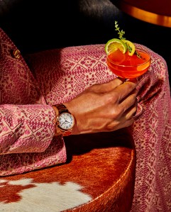Ballon Bleu de Cartier's watch, 18-karat rose gold, 40 mm. Cartier Love 18-karat rose gold bracelet. Gucci wool suit. Firetip drink
