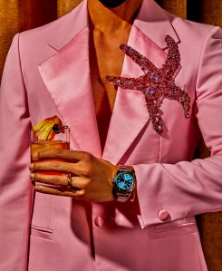 RolexÕs Milgauss 40-mm Oystersteel watch. Versace wool and mohair jacket. Trinity de Cartier ring, small model, 18-karat white gold, 18-karat yellow gold, 18-karat rose gold. Golden Piper drink.