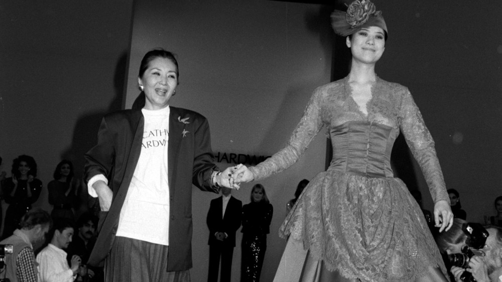 Designer Cathy Hardwick and model Ariane Koizumi walk her Fall 1986 Ready To Wear show finale.