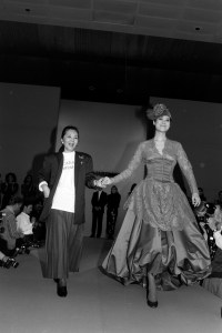 Designer Cathy Hardwick and model Ariane Koizumi walk her Fall 1986 Ready To Wear show finale.