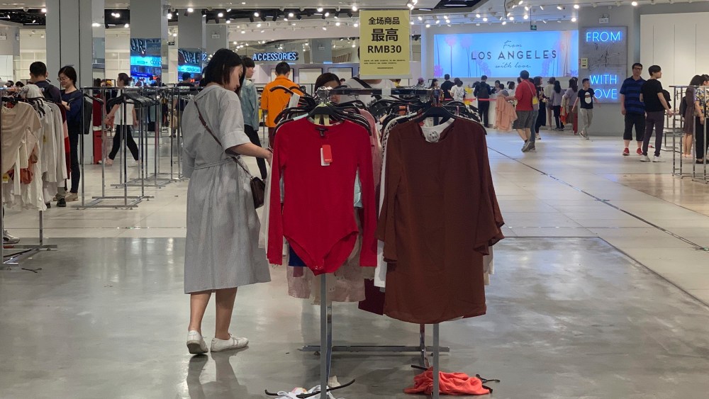 Customers shop at a store of Forever 21 to close down at a shopping mall in Beijing, China, 20 May 2019. A growing number of foreign fast fashion brands that used to fill the wardrobes of young Chinese have been going out of style. On Thursday afternoon, the three-story Forever 21 store on Changde Road in Shanghai was in disarray. The store was holding a big fire sale to liquidate its inventory, with all items selling for 30 yuan ($4.38) or less. Some counters were cluttered with piles of dumped shoes and clothes, and customers were rummaging through the piles as if searching for treasures in a rubbish heap. A salesperson at the store told the Global Times on Sunday that Forever 21 is soon going to exit the mainland market, but she said she hadn't heard from the company about the exact date.  (Imaginechina via AP Images)