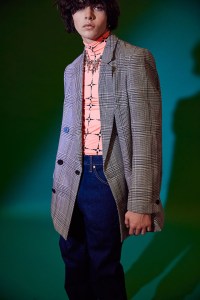 Overcoat’s wool blazer worn over The Stolen Garment’s polyester and elastane turtleneck and Levi’s cotton and elastane denim jeans.