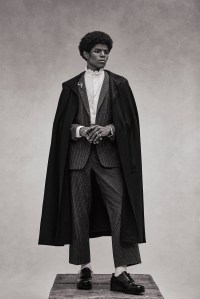 Celine Homme by Hedi Slimane’s flannel wool gabardine cape, flannel suit and cotton shirt. RJ Graziano brooch; Prada shoes.