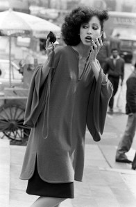 Model Pat Cleveland poses in a cashmere choirgirl tunic from Halston's fall 1981 ready to wear advance with an Elsa Peretti-designed cosmetic compact.