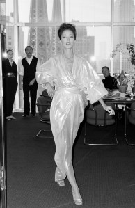 Model Pat Cleveland poses in a look from Halston's 1982 resort collection advance with Roy Halston (seated), D.D. Ryan and an assistant at the Olympic Towers on August 3, 1982.