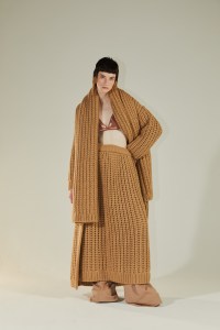 Altuzarra’s knit sweater, skirt, and scarf over Cult Gaia’s cotton bikini top and Gabriela Hearst’s upcycled wool pants.
