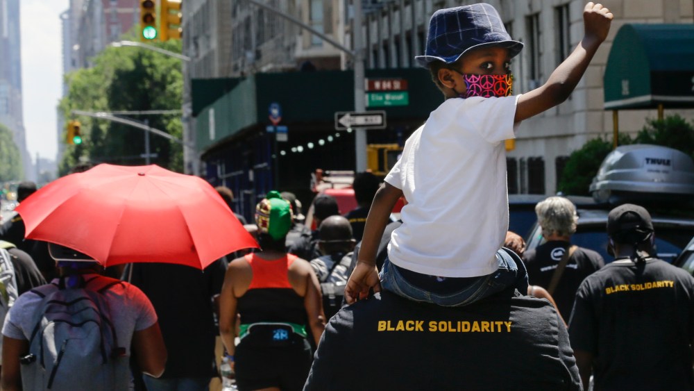FILE - In this June 19, 2020, photograph, a man carries a child on his shoulders as they march near Central Park during a Juneteenth celebration, in New York. New York Gov. Andrew Cuomo signed legislation Wednesday, Oct. 14, 2020, officially making Juneteenth, a day commemorating the emancipation of enslaved people in the United States, a New York state holiday. Although President Abraham Lincoln issued the Emancipation Proclamation on Jan. 1, 1863, not everyone heard about it right away. It wasn't until June 19, 1865, that enslaved people in Galveston, Texas, found out about it from Union army personnel, making them among the last to know about their freedom. (AP Photo/Frank Franklin II, File)