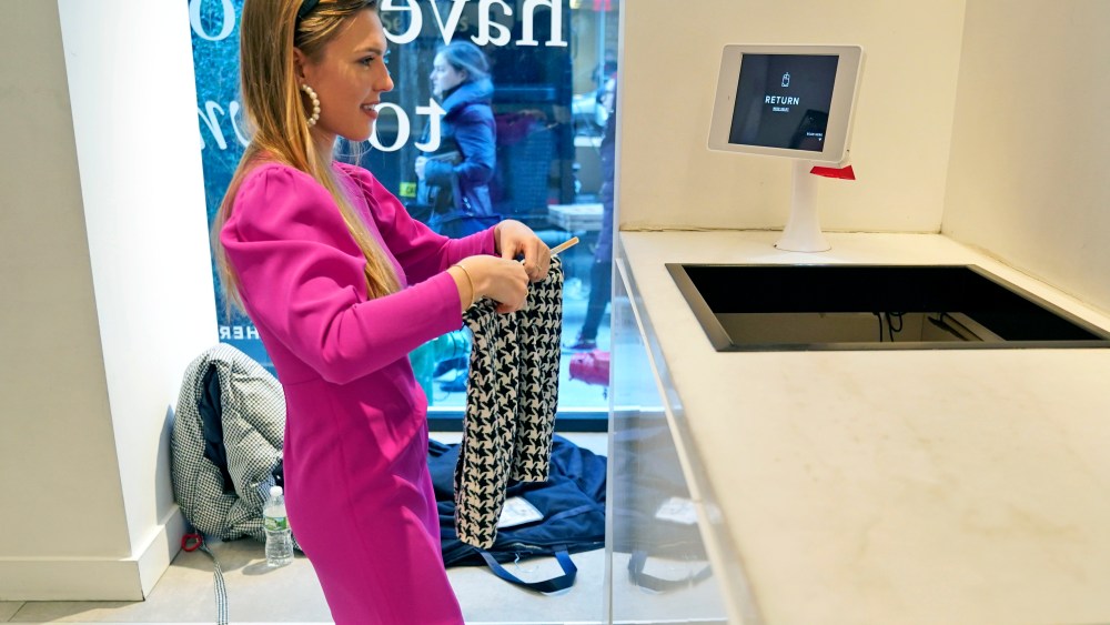 In this Monday, Nov. 25, 2019 photo, Vara Pikor returns some items to a "Rent The Runway" store in New York. Vikor is wearing some of the items she rents from the company, including her dress and earrings. Now a booming $1 billion business, the clothing rental sector is expected to reach $2.5 billion by 2023, says research firm GlobalData. But for traditional retailers, the economics of renting affordable clothing pose significant challenges.   (AP Photo/Seth Wenig)