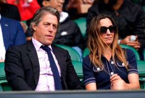 Wimbledon 2021 - Day Nine - The All England Lawn Tennis and Croquet Club. Hugh Grant (left) and Anna Elisabet Eberstein in centre court on day nine of Wimbledon at The All England Lawn Tennis and Croquet Club, Wimbledon. Picture date: Wednesday July 7, 2021. See PA story TENNIS Wimbledon. Photo credit should read: John Walton/PA Wire RESTRICTIONS: Editorial use only. No commercial use without prior written consent of the AELTC. Still image use only - no moving images to emulate broadcast. No superimposing or removal of sponsor/ad logos. URN:60799996 (Press Association via AP Images)