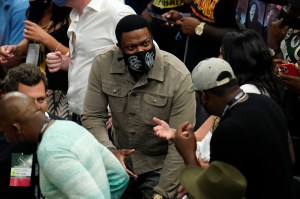 Comedian and actor Chris Tucker talks in the stands during the first half of Game 6 of basketball's NBA Finals between the Milwaukee Bucks and the Phoenix Suns in Milwaukee, Tuesday, July 20, 2021. (AP Photo/Paul Sancya)