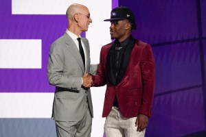 Davion Mitchell, right, is greeted by NBA Commissioner Adam Silver after being selected ninth overall by the Sacramento Kings during the NBA basketball draft, Thursday, July 29, 2021, in New York. (AP Photo/Corey Sipkin)
