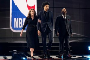 Cade Cunningham, center, walks with his parents, Carrie, left, and Keith Cunningham during the NBA basketball draft, Thursday, July 29, 2021, in New York. Cunningham was selected first overall by the Detroit Pistons. (AP Photo/Corey Sipkin)