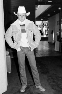 A model poses in Levi's denim jeans, shearling jacket and cowboy hat for the 1984 Winter Olympics ceremonies during a promotional presentation at UCLA on September 2, 1981.