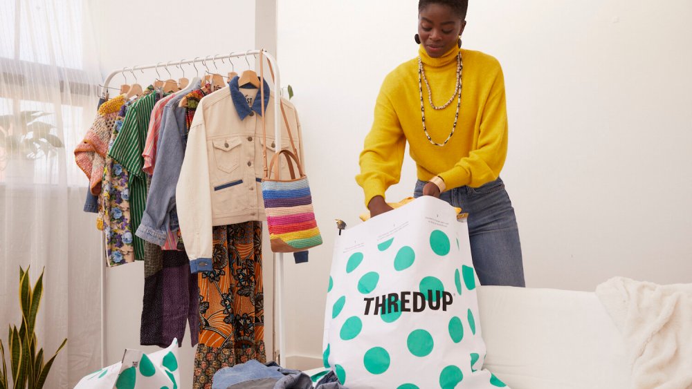 woman filling ThredUp cleanup bag