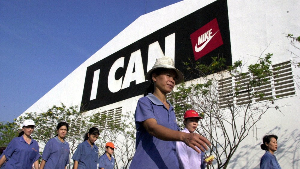 Workers arrive at the Chang Shin Nike shoe factory in Bien Hoa, Dong Nai province south of Ho Chi Minh City, March 15, 2001. The 300,000-plus pairs of shoes a month that come out of this compound are headed all over the world, 30 percent to the United States alone.
