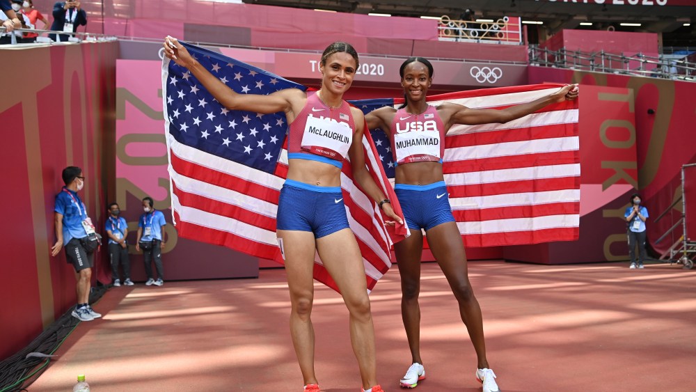 Sydney Mclaughlin, left, and Dalilah Muhammad, both of the United States, celebrate after finishing first and second respectively in the women's 400-meter hurdles during the 2020 Summer Olympics on Wednesday, Aug. 4, 2021, in Tokyo, Japan. (Andrej Isakovic/Pool Photo via AP)