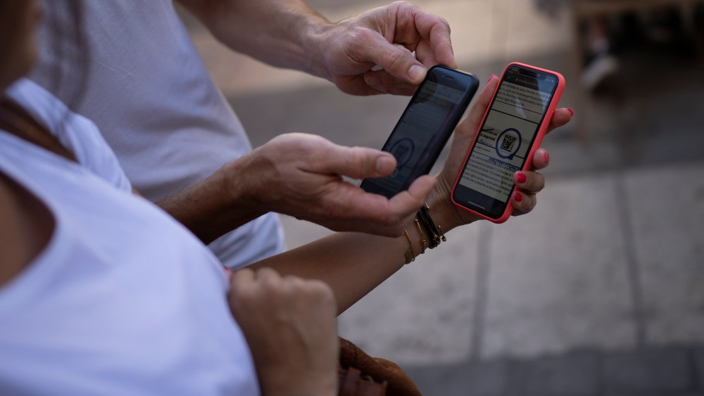 A person scanning a COVID-19 health pass in France