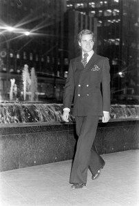 A model poses in a double-breasted flair leg suit from Yves Saint Laurent's fall 1975 menswear collection advance.