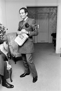 Designer Pierre Cardin reads DNR (The Daily News Record before his boutique opening at Bonwit Teller's Department Store, New York