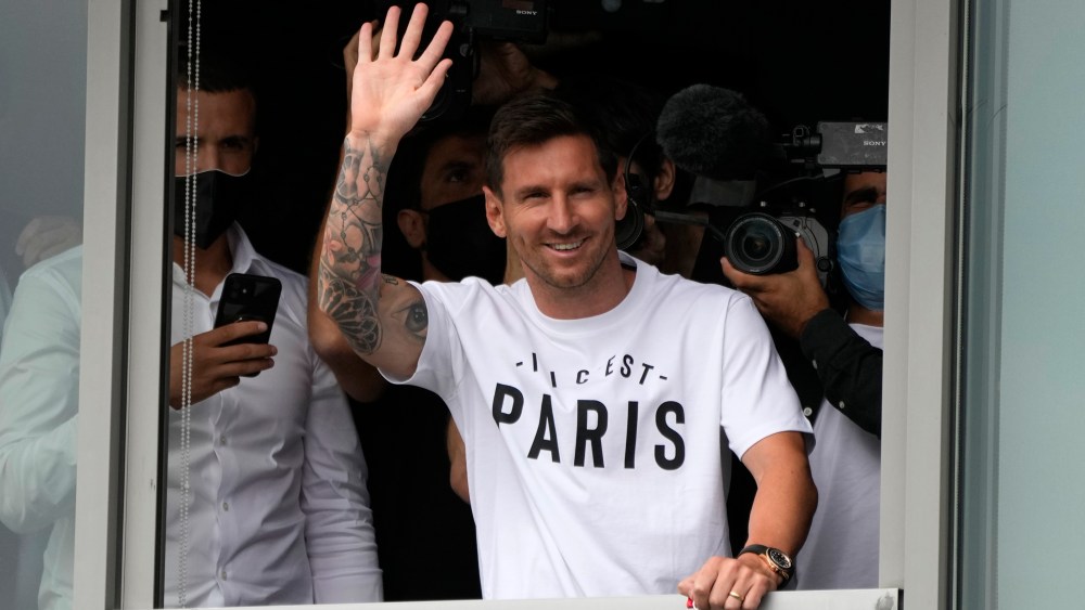 Lionel Messi waves after arriving at Le Bourget airport, north of Paris, Tuesday, Aug. 10, 2021. Lionel Messi finalized agreement on his Paris Saint-Germain contract and was flying to France on Tuesday to complete the move that confirms the end of a career-long association with Barcelona. (AP Photo/Francois Mori)