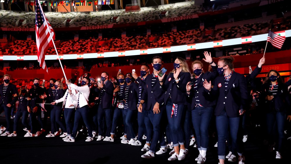 TOKYO, JAPAN - JULY 23: Flag bearers Sue Bird and Eddy Alvares of Team United States lead their team out during the Opening Ceremony of the Tokyo 2020 Olympic Games at Olympic Stadium on July 23, 2021 in Tokyo, Japan. (Photo by Jamie Squire/Getty Images)