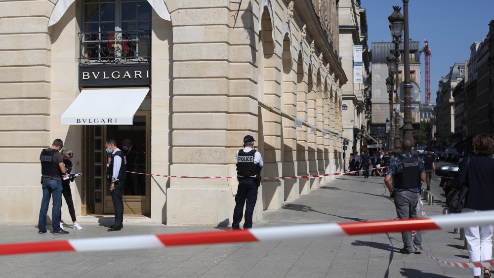 Police officers stand outside the Bulgari jewelry after they arrest two suspects following a Bulgari jewelry heist on the posh Place Vendome in Paris, Tuesday, Sept.7, 2021. One of the suspects was shot in the leg by an officer before being arrested. (AP Photo/Rafael Yaghobzadeh)
