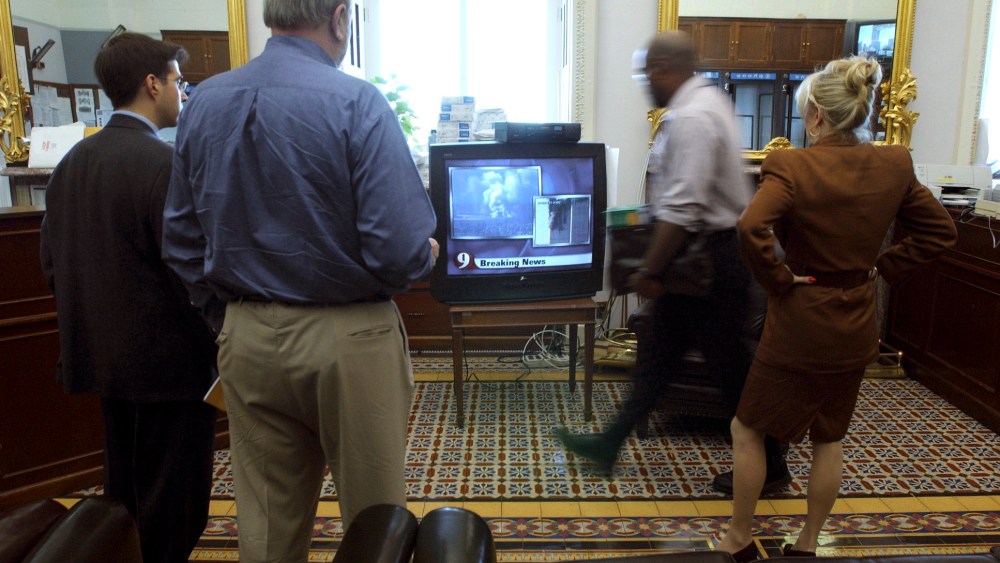 People watch newscasts of terrorist attacks in the Senate Press Gallery shortly before the Capitol was evacuated, on September 11, 2001.